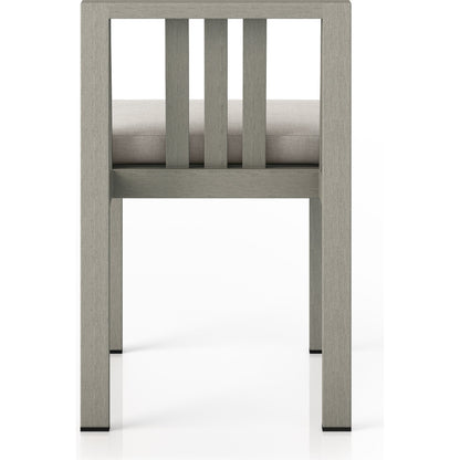 Monterey Outdoor Dining Chair by Four Hands in washed brown. Made from 100% olefin, solid fsc®-certified teak, 91% polyurethane foam pad, 9% polyester fiber batting in a modern style.