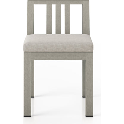 Monterey Outdoor Dining Chair by Four Hands in washed brown. Made from 100% olefin, solid fsc®-certified teak, 91% polyurethane foam pad, 9% polyester fiber batting in a modern style.