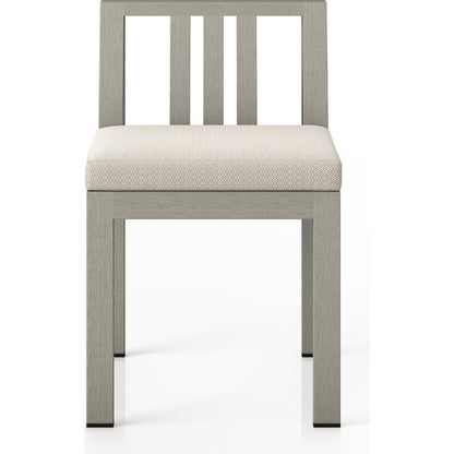 Monterey Outdoor Dining Chair by Four Hands in washed brown. Made from 100% olefin, solid fsc®-certified teak, 91% polyurethane foam pad, 9% polyester fiber batting in a modern style.