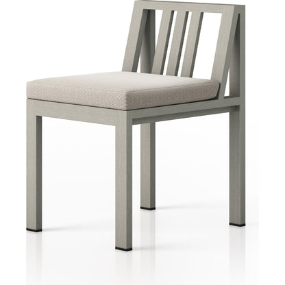 Monterey Outdoor Dining Chair by Four Hands in washed brown. Made from 100% olefin, solid fsc®-certified teak, 91% polyurethane foam pad, 9% polyester fiber batting in a modern style.