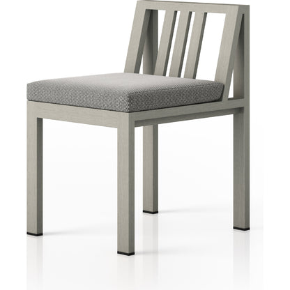 Monterey Outdoor Dining Chair by Four Hands in washed brown. Made from 100% olefin, solid fsc®-certified teak, 91% polyurethane foam pad, 9% polyester fiber batting in a modern style.