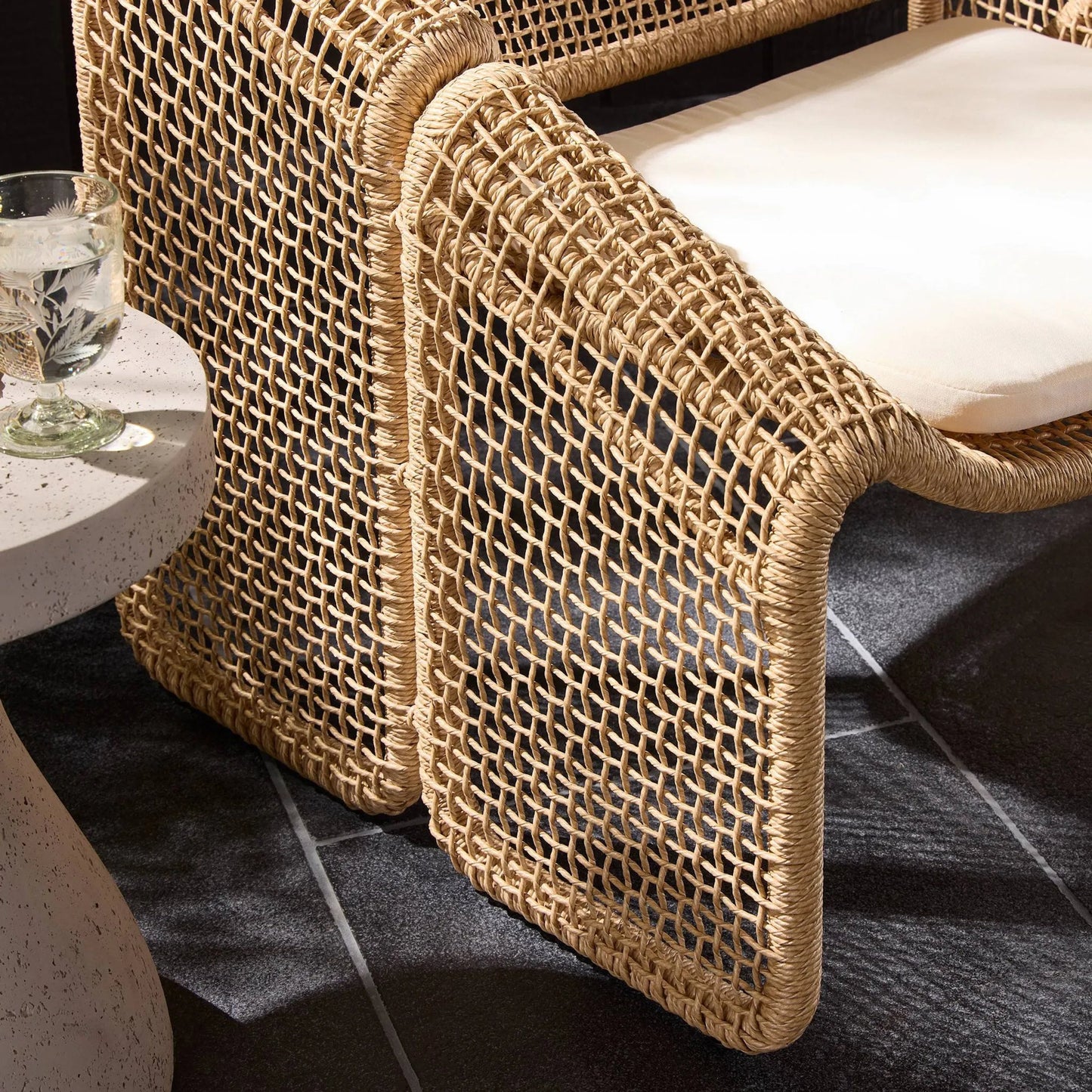 025 SI-1798266 | Closeup | Selma Outdoor Chair by Four Hands. Made from 100% olefin, 100% polyethylene, 91% polyurethane foam pad, 9% polyester fiber batting in a coastal style.