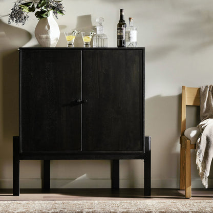 Reza Bar Cabinet by Four Hands in smoked honey parawood. Made from solid parawood, brass, solid acacia in a transitional style.