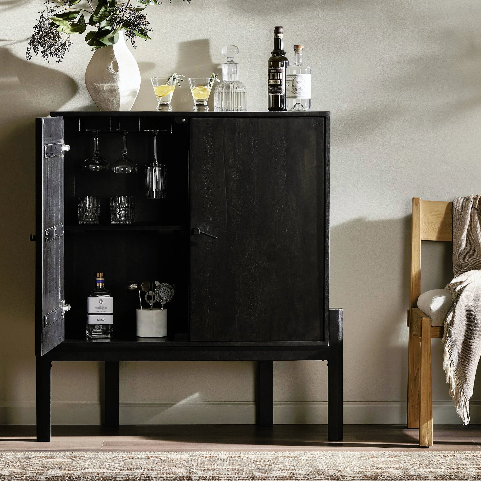 Reza Bar Cabinet by Four Hands in smoked honey parawood. Made from solid parawood, brass, solid acacia in a transitional style.