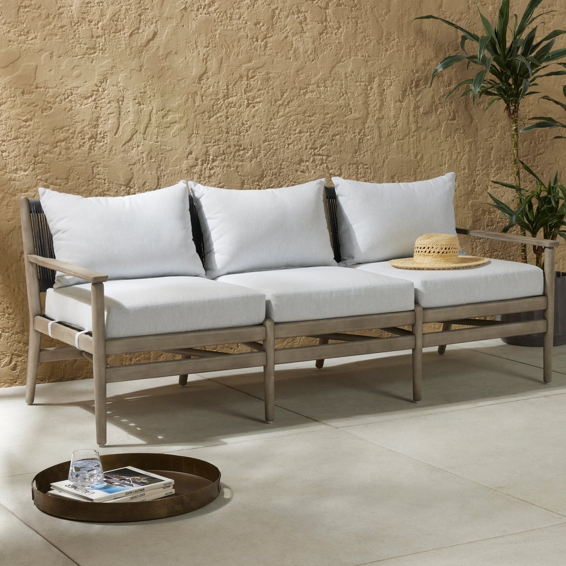 Rosen Outdoor Sofa by Four Hands in lakin oat, natural eucalyptus fsc, natural rope. Made from 100% olefin, solid fsc®-certified eucalyptus, 98% polypropylene, 2% polyester in a coastal style.