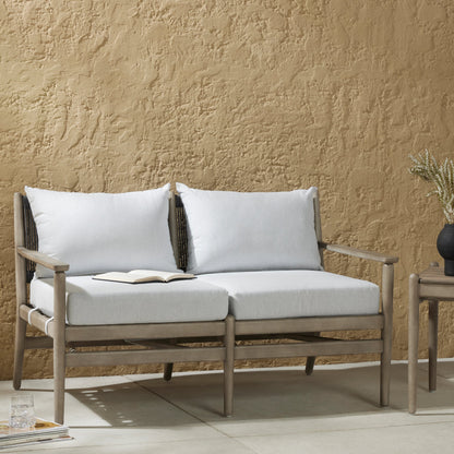 Rosen Outdoor Sofa by Four Hands in lakin oat, natural eucalyptus fsc, natural rope. Made from 100% olefin, solid fsc®-certified eucalyptus, 98% polypropylene, 2% polyester in a coastal style.