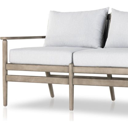 Rosen Outdoor Sofa by Four Hands in lakin oat, natural eucalyptus fsc, natural rope. Made from 100% olefin, solid fsc®-certified eucalyptus, 98% polypropylene, 2% polyester in a coastal style.