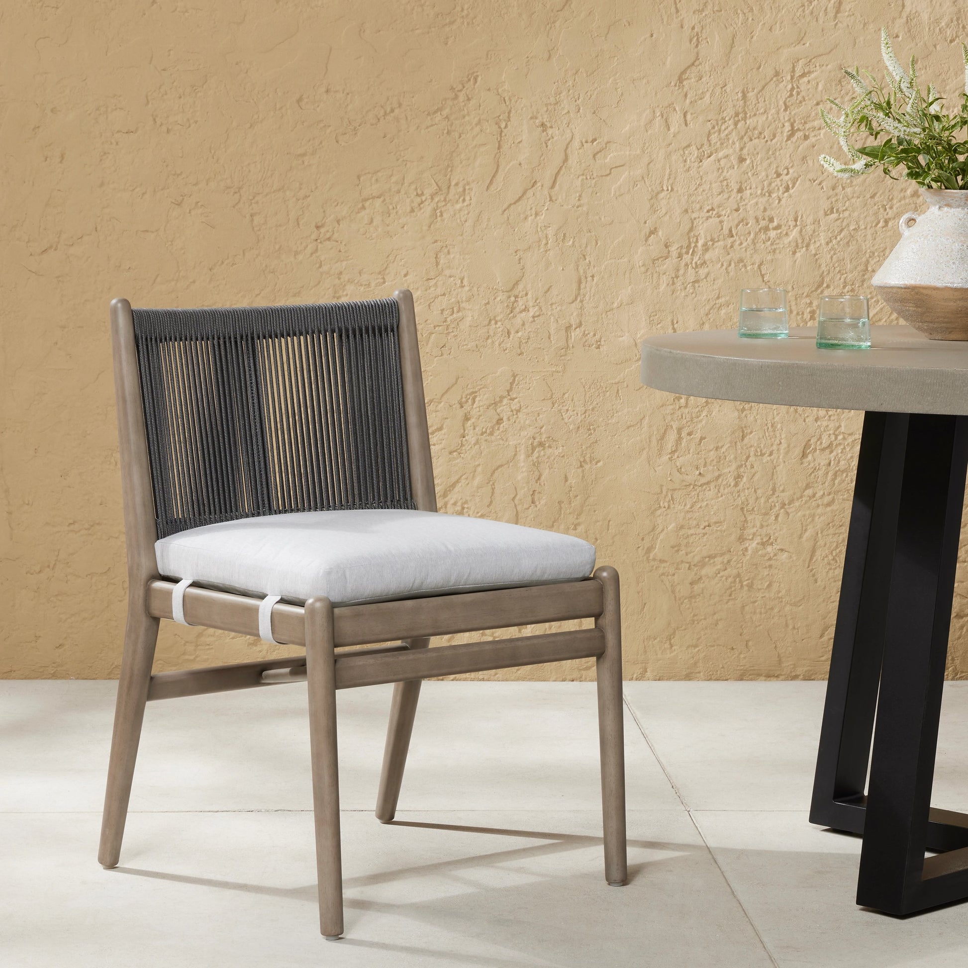 Rosen Outdoor Dining Chair by Four Hands in lakin oat. Made from 100% olefin, solid fsc®-certified eucalyptus, 98% polypropylene, 2% polyester in a coastal style.