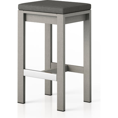Monterey Bar Stool by Four Hands in faye navy and weathered grey. Made from 100% olefin, solid fsc®-certified teak, 91% polyurethane foam pad, 9% polyester fiber batting in a modern style.