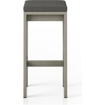 Monterey Bar Stool by Four Hands in faye navy and weathered grey. Made from 100% olefin, solid fsc®-certified teak, 91% polyurethane foam pad, 9% polyester fiber batting in a modern style.