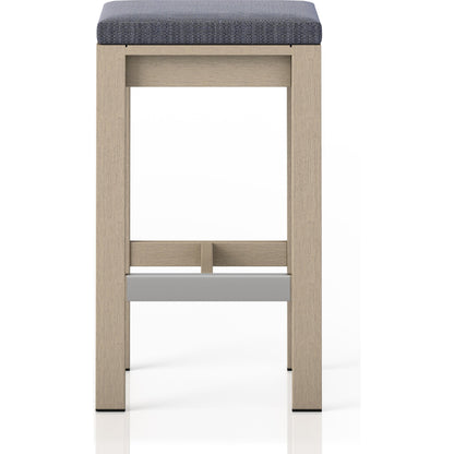 Monterey Bar Stool by Four Hands in faye navy and weathered grey. Made from 100% olefin, solid fsc®-certified teak, 91% polyurethane foam pad, 9% polyester fiber batting in a modern style.