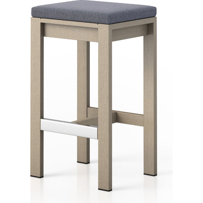Monterey Bar Stool by Four Hands in faye navy and weathered grey. Made from 100% olefin, solid fsc®-certified teak, 91% polyurethane foam pad, 9% polyester fiber batting in a modern style.