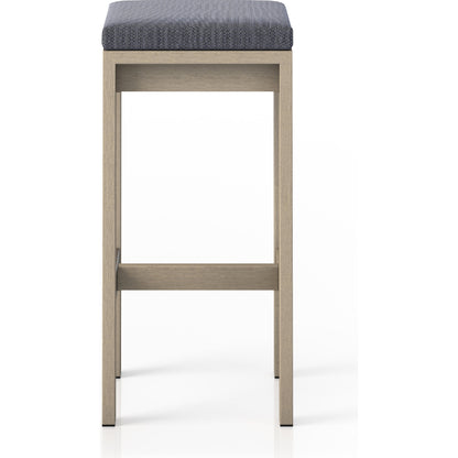 Monterey Bar Stool by Four Hands in faye navy and weathered grey. Made from 100% olefin, solid fsc®-certified teak, 91% polyurethane foam pad, 9% polyester fiber batting in a modern style.