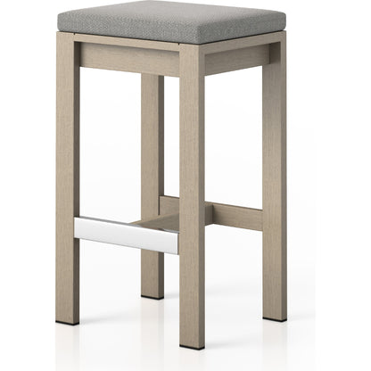 Monterey Bar Stool by Four Hands in faye navy and weathered grey. Made from 100% olefin, solid fsc®-certified teak, 91% polyurethane foam pad, 9% polyester fiber batting in a modern style.