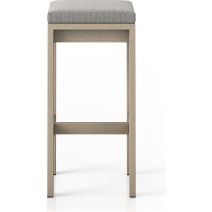 Monterey Bar Stool by Four Hands in faye navy and weathered grey. Made from 100% olefin, solid fsc®-certified teak, 91% polyurethane foam pad, 9% polyester fiber batting in a modern style.
