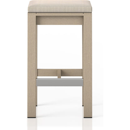 Monterey Bar Stool by Four Hands in faye navy and weathered grey. Made from 100% olefin, solid fsc®-certified teak, 91% polyurethane foam pad, 9% polyester fiber batting in a modern style.