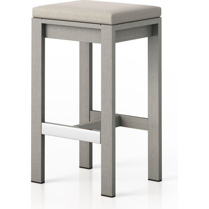 Monterey Bar Stool by Four Hands in faye navy and weathered grey. Made from 100% olefin, solid fsc®-certified teak, 91% polyurethane foam pad, 9% polyester fiber batting in a modern style.