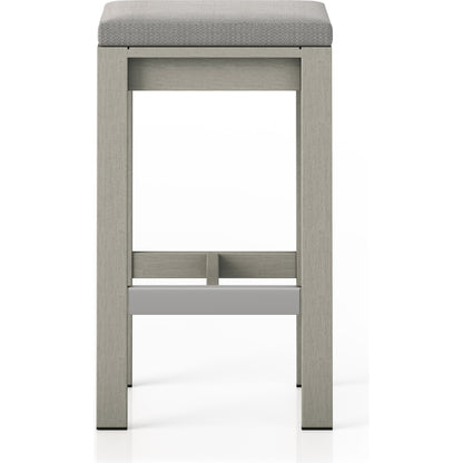 Monterey Bar Stool by Four Hands in faye navy and weathered grey. Made from 100% olefin, solid fsc®-certified teak, 91% polyurethane foam pad, 9% polyester fiber batting in a modern style.