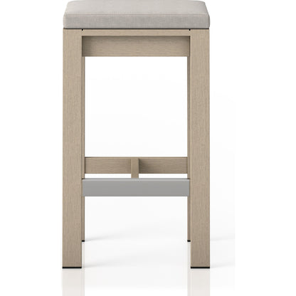 Monterey Bar Stool by Four Hands in faye navy and weathered grey. Made from 100% olefin, solid fsc®-certified teak, 91% polyurethane foam pad, 9% polyester fiber batting in a modern style.