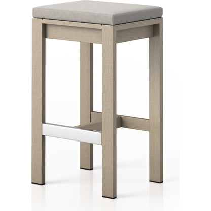 Monterey Bar Stool by Four Hands in faye navy and weathered grey. Made from 100% olefin, solid fsc®-certified teak, 91% polyurethane foam pad, 9% polyester fiber batting in a modern style.