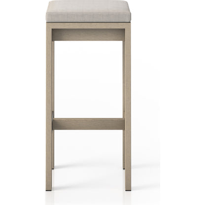 Monterey Bar Stool by Four Hands in faye navy and weathered grey. Made from 100% olefin, solid fsc®-certified teak, 91% polyurethane foam pad, 9% polyester fiber batting in a modern style.