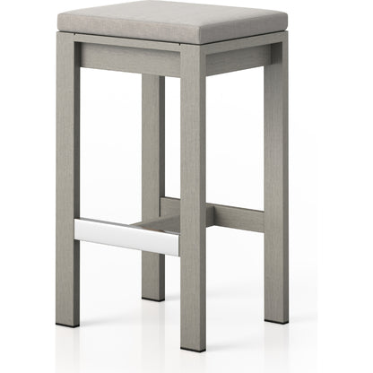 Monterey Bar Stool by Four Hands in faye navy and weathered grey. Made from 100% olefin, solid fsc®-certified teak, 91% polyurethane foam pad, 9% polyester fiber batting in a modern style.