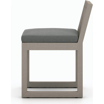 Avalon Outdoor Armless Dining Chair by Four Hands in charcoal / grey. Made from 100% olefin, solid fsc®-certified teak, 91% polyurethane foam pad, 9% polyester fiber batting in a modern style.