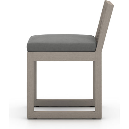 Avalon Outdoor Armless Dining Chair by Four Hands in charcoal / grey. Made from 100% olefin, solid fsc®-certified teak, 91% polyurethane foam pad, 9% polyester fiber batting in a modern style.