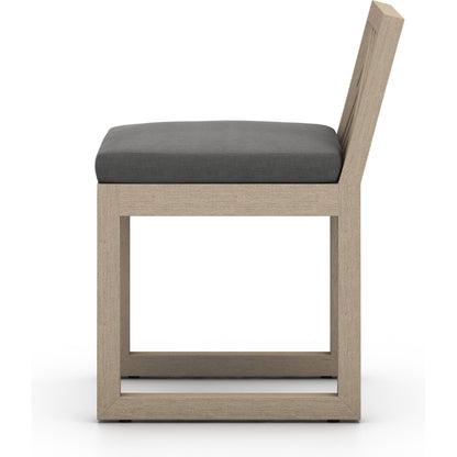 Avalon Outdoor Armless Dining Chair by Four Hands in charcoal / grey. Made from 100% olefin, solid fsc®-certified teak, 91% polyurethane foam pad, 9% polyester fiber batting in a modern style.