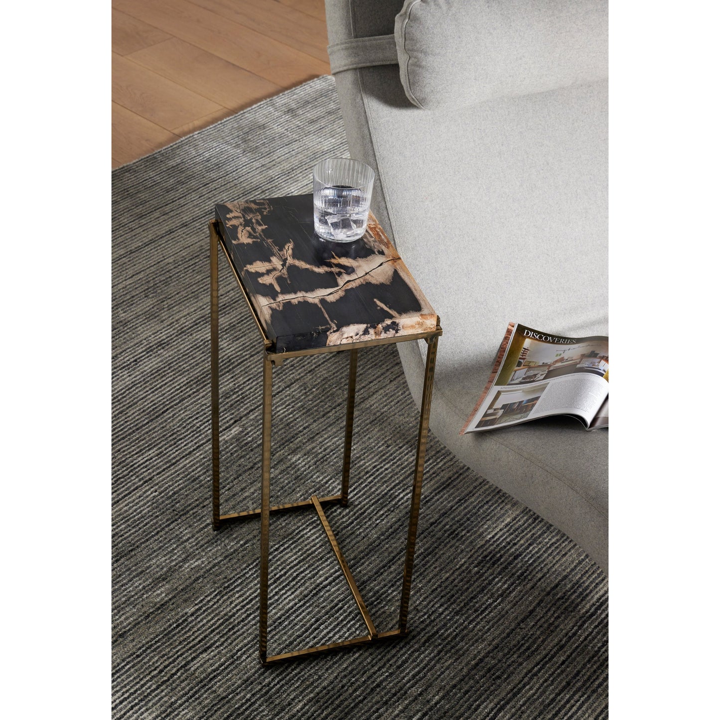 010 SI-1800169 | Lifestyle | Tig End Table by Four Hands in textured brass, dark petrified wood. Made from petrified wood, stainless steel in a transitional style.