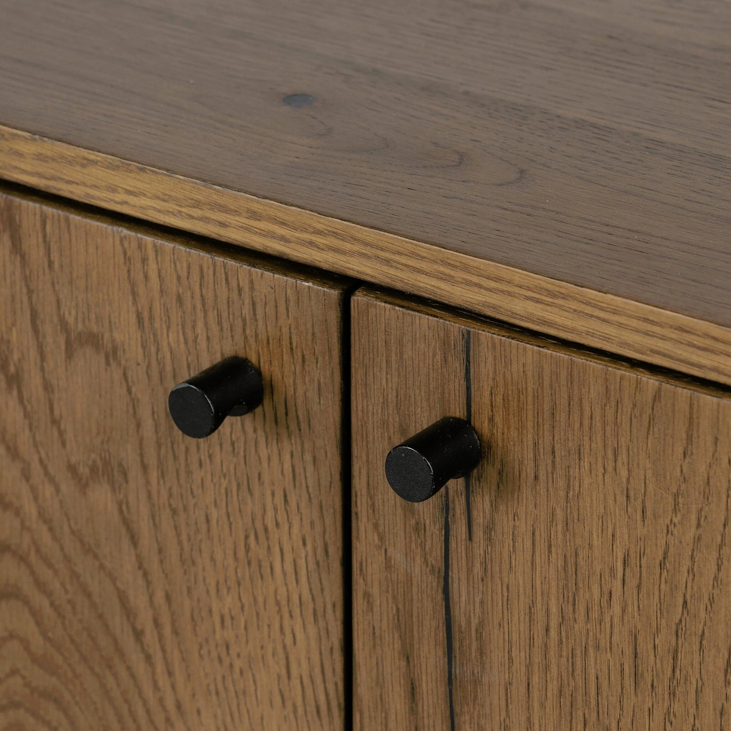 022 SI-1902696 | Closeup | Eaton Sideboard by Four Hands in amber oak resin, dark gunmetal and amber oak. Made from thick oak veneer, iron in a modern style.