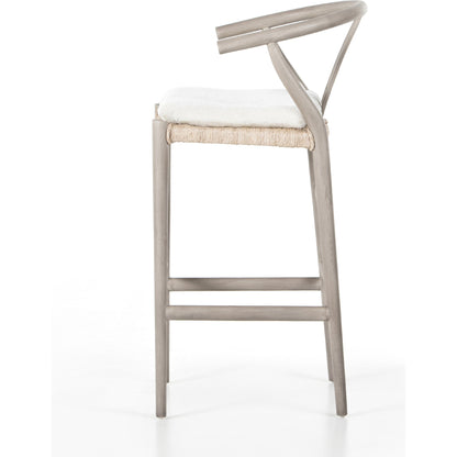 Muestra Bar Stool by Four Hands in vintage white, natural teak. Made from solid teak, 100% polyethylene in a coastal style.