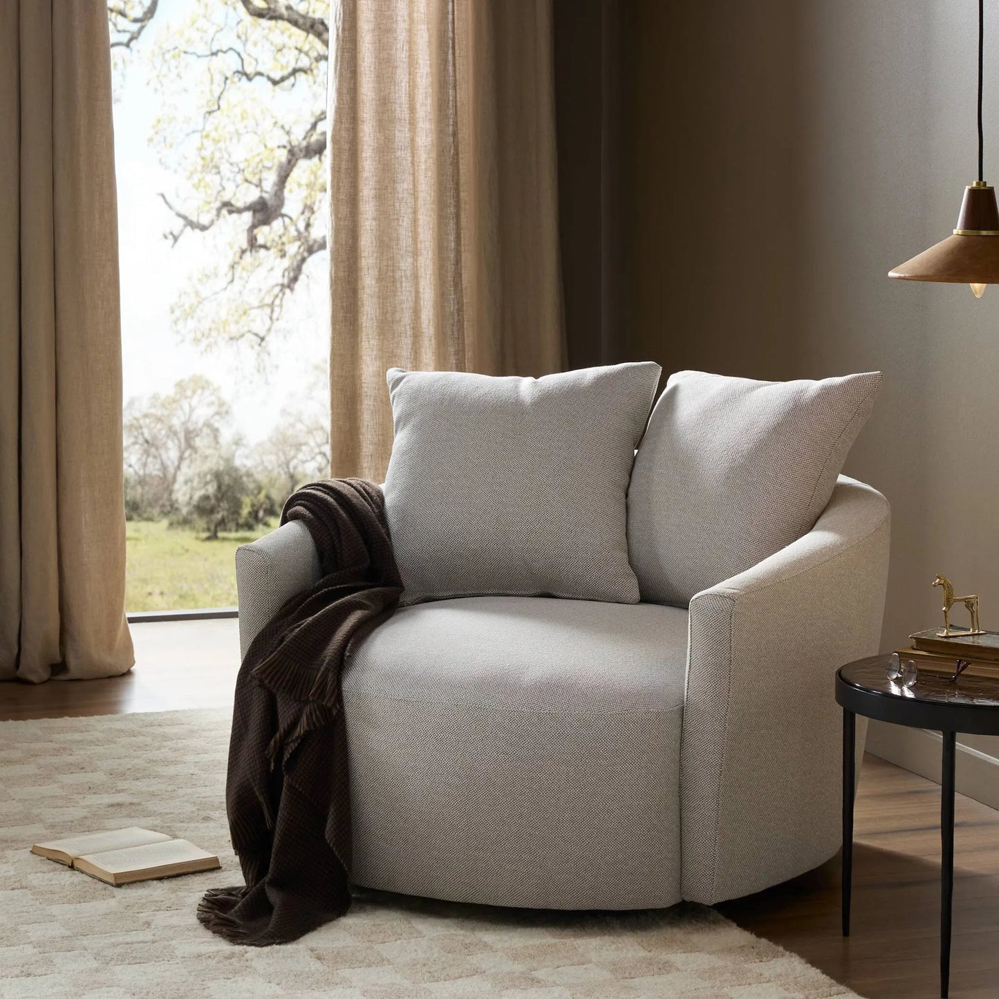 098 SI-1901513 | Lifestyle | Chloe Swivel Chair by Four Hands in delta bisque. Made from 97% olefin, 3% polyester, solid pine, 51% post consumer recycled polyester, 49% polyester in a modern style.