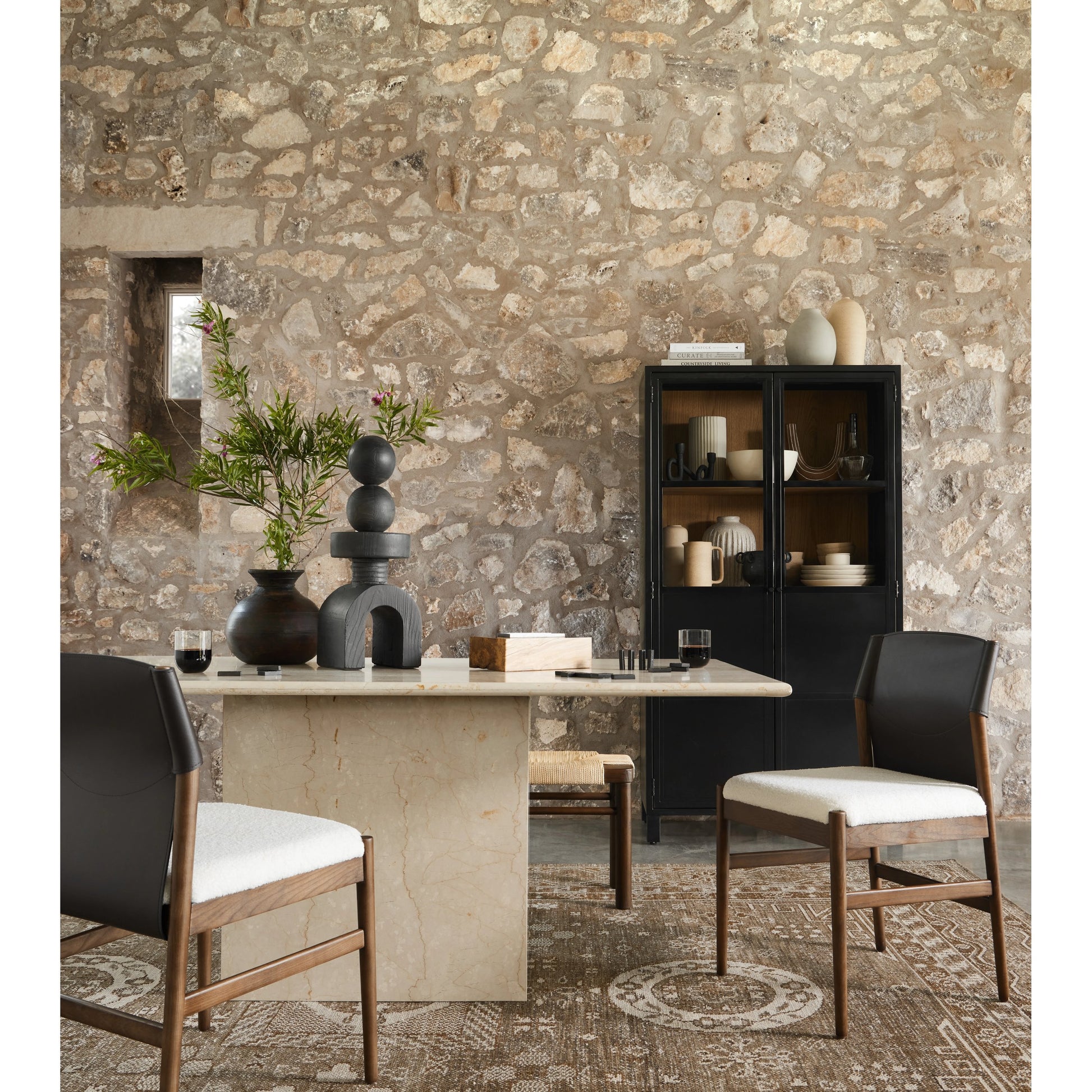 Arum Dining Table by Four Hands in cream marble. Made from solid marble in a coastal style.