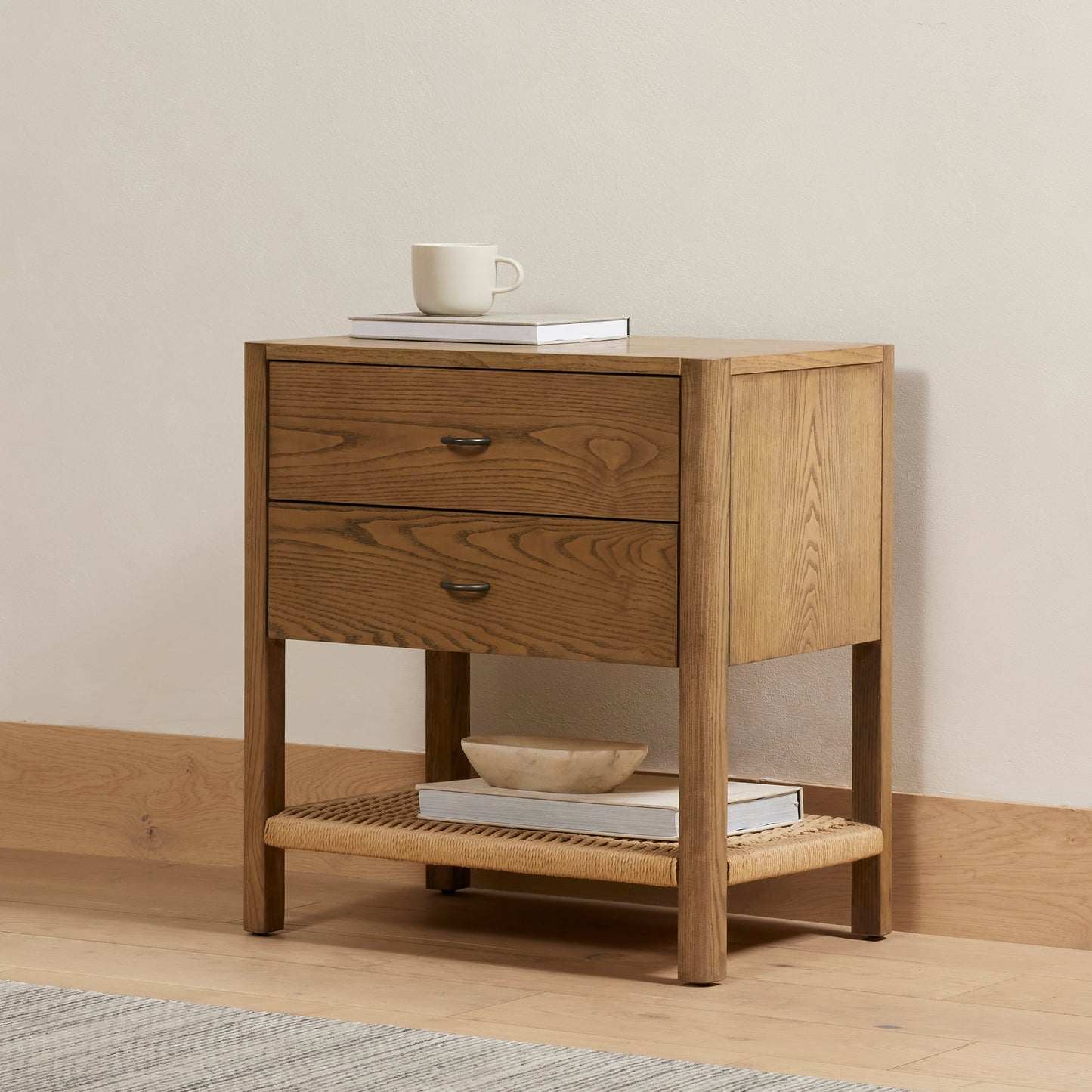 013 SI-1901641 | Lifestyle | Zuma Nightstand by Four Hands in dune ash veneer, gunmetal, natural paper cord and dune ash. Made from ash veneer, rush in a cottage & farmhouse style.