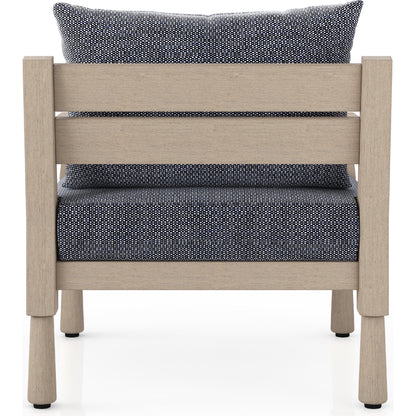 Waller Outdoor Chair by Four Hands in stone grey, weathered grey and weathered grey in stone grey. Made from 100% olefin, solid fsc®-certified teak, 59% polyurethane foam, 30% polyester fiber, 11% polyester fiber batting in a transitio