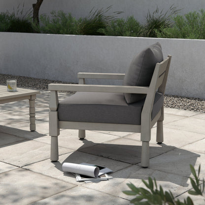 Waller Outdoor Chair by Four Hands in stone grey, weathered grey and weathered grey in stone grey. Made from 100% olefin, solid fsc®-certified teak, 59% polyurethane foam, 30% polyester fiber, 11% polyester fiber batting in a transitio