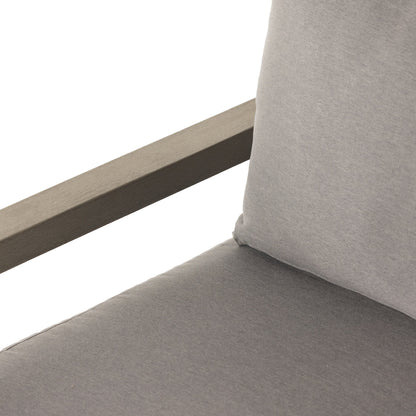 Waller Outdoor Chair by Four Hands in stone grey, weathered grey and weathered grey in stone grey. Made from 100% olefin, solid fsc®-certified teak, 59% polyurethane foam, 30% polyester fiber, 11% polyester fiber batting in a transitio