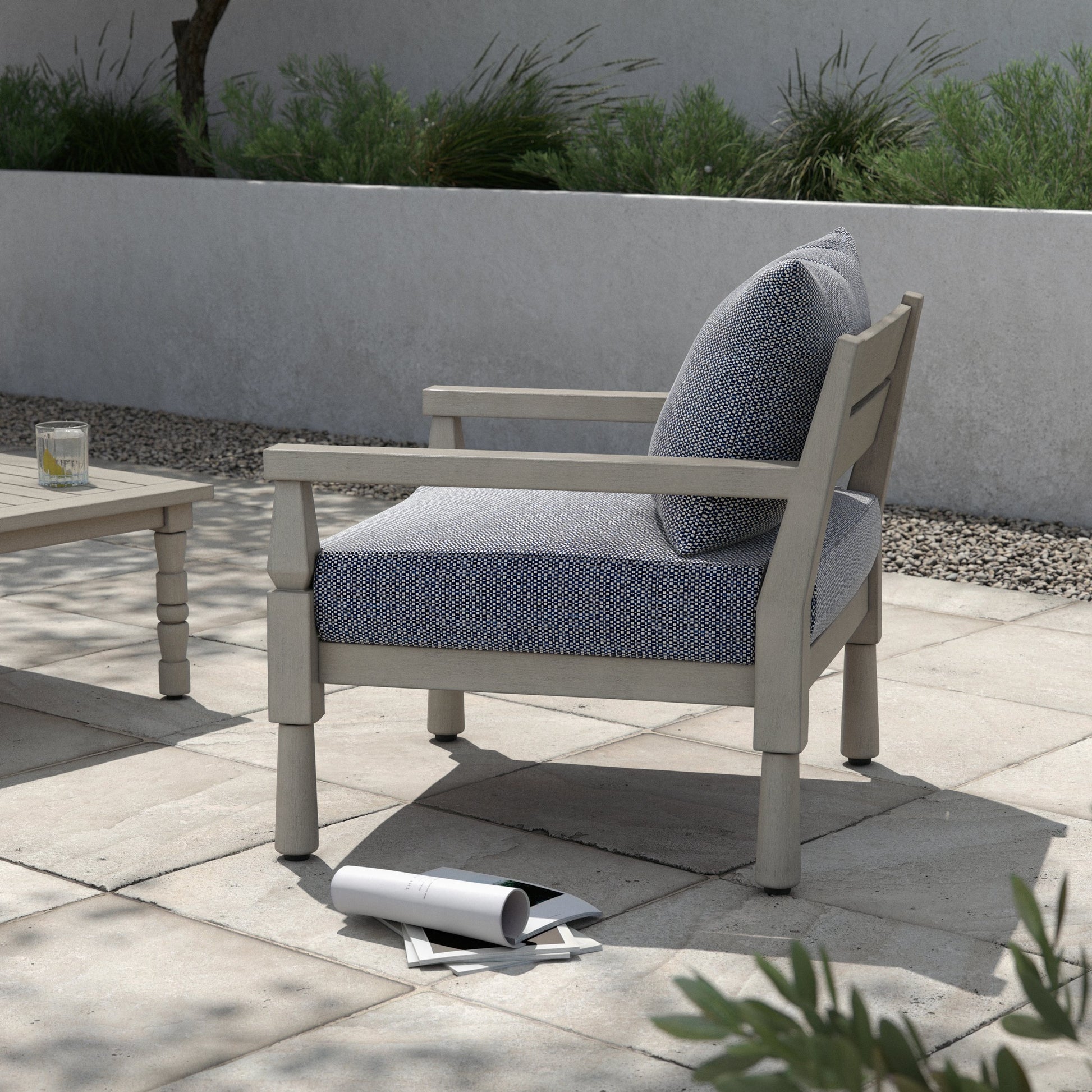 Waller Outdoor Chair by Four Hands in stone grey, weathered grey and weathered grey in stone grey. Made from 100% olefin, solid fsc®-certified teak, 59% polyurethane foam, 30% polyester fiber, 11% polyester fiber batting in a transitio