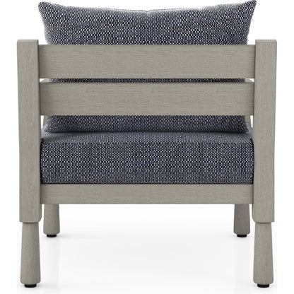 Waller Outdoor Chair by Four Hands in stone grey, weathered grey and weathered grey in stone grey. Made from 100% olefin, solid fsc®-certified teak, 59% polyurethane foam, 30% polyester fiber, 11% polyester fiber batting in a transitio
