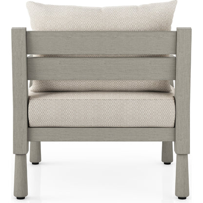 Waller Outdoor Chair by Four Hands in stone grey, weathered grey and weathered grey in stone grey. Made from 100% olefin, solid fsc®-certified teak, 59% polyurethane foam, 30% polyester fiber, 11% polyester fiber batting in a transitio