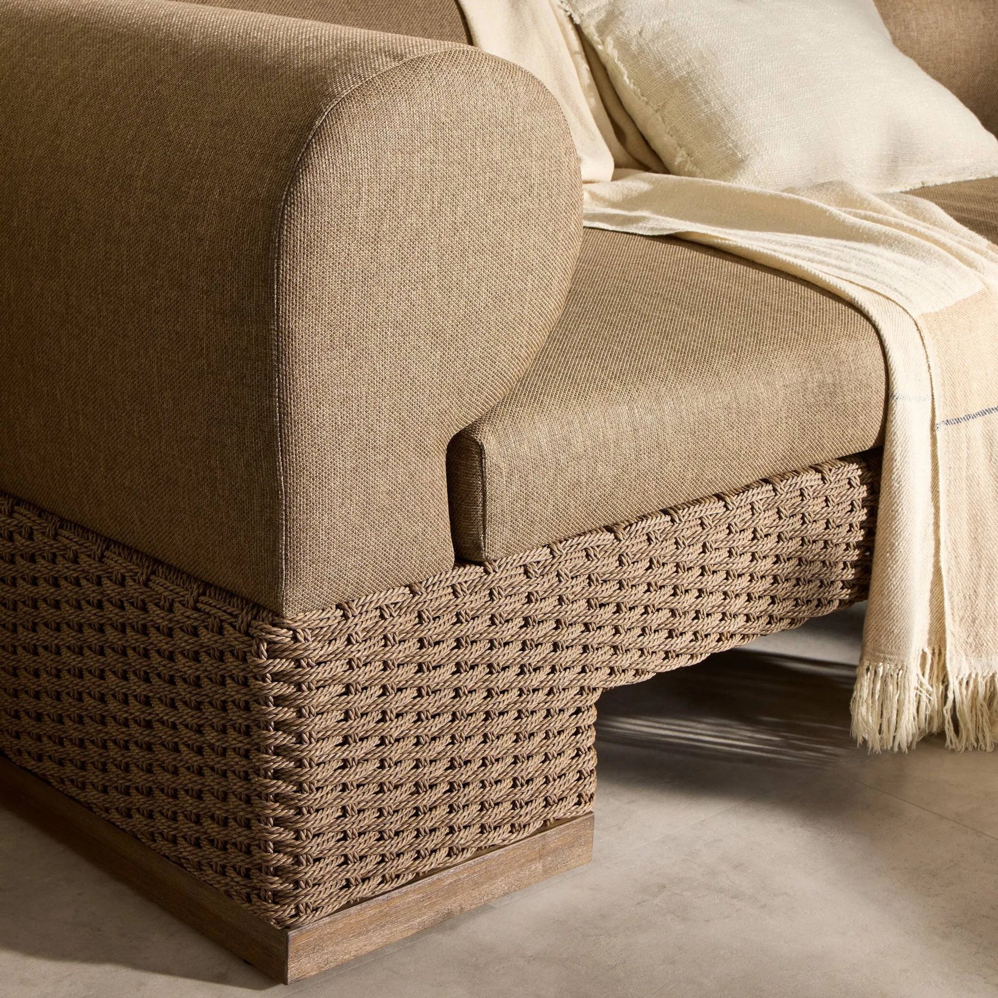 Joss Outdoor Sofa by Four Hands. Made from 100% olefin, solid teak, 100% polyethylene in a coastal style.