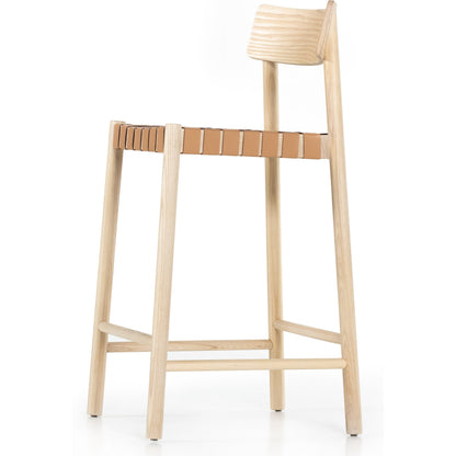 Heisler Counter Stool by Four Hands in almond leather and black. Made from 70% split leather, 30% polyvinyl chloride (pvc), solid ash, ash veneer in a transitional style.