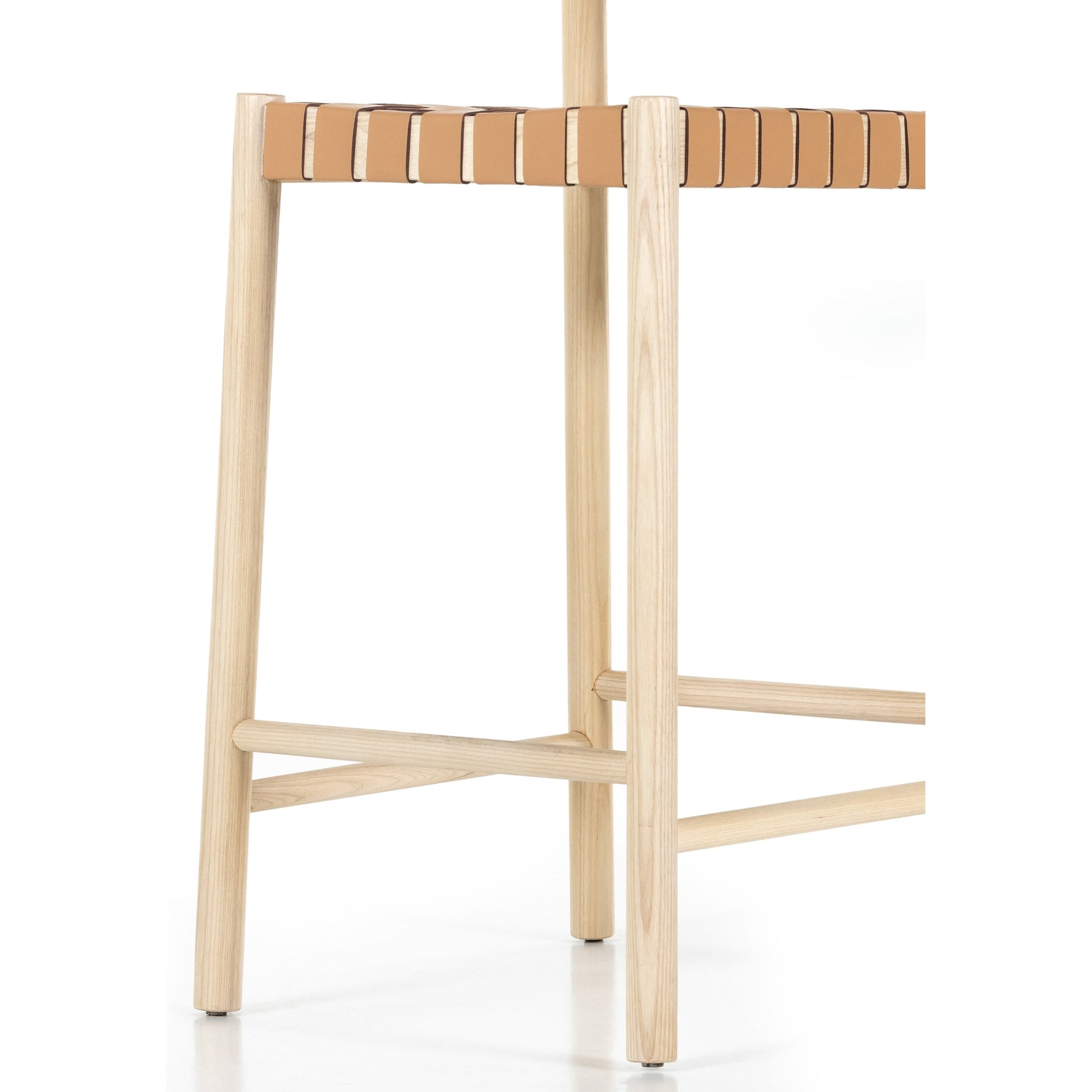 Heisler Counter Stool by Four Hands in almond leather and black. Made from 70% split leather, 30% polyvinyl chloride (pvc), solid ash, ash veneer in a transitional style.