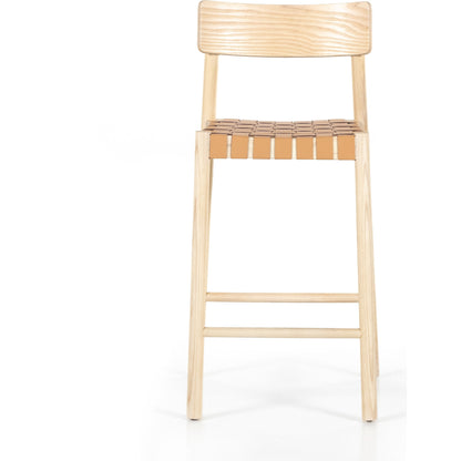 Heisler Counter Stool by Four Hands in almond leather and black. Made from 70% split leather, 30% polyvinyl chloride (pvc), solid ash, ash veneer in a transitional style.