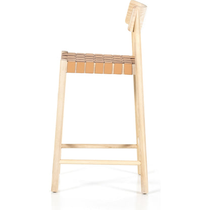 Heisler Counter Stool by Four Hands in almond leather and black. Made from 70% split leather, 30% polyvinyl chloride (pvc), solid ash, ash veneer in a transitional style.