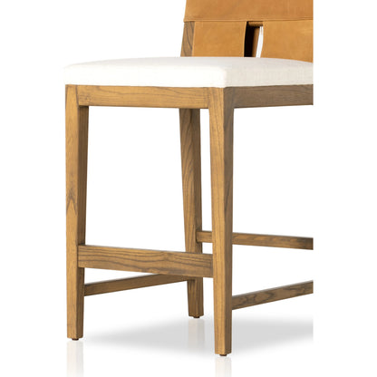 Sem Counter Stool by Four Hands in palermo butterscotch, lamont nettlewood, halcyon ivory. Made from 92% polyester, 8% flax, linen, solid nettlewood, top grain leather in a modern style.