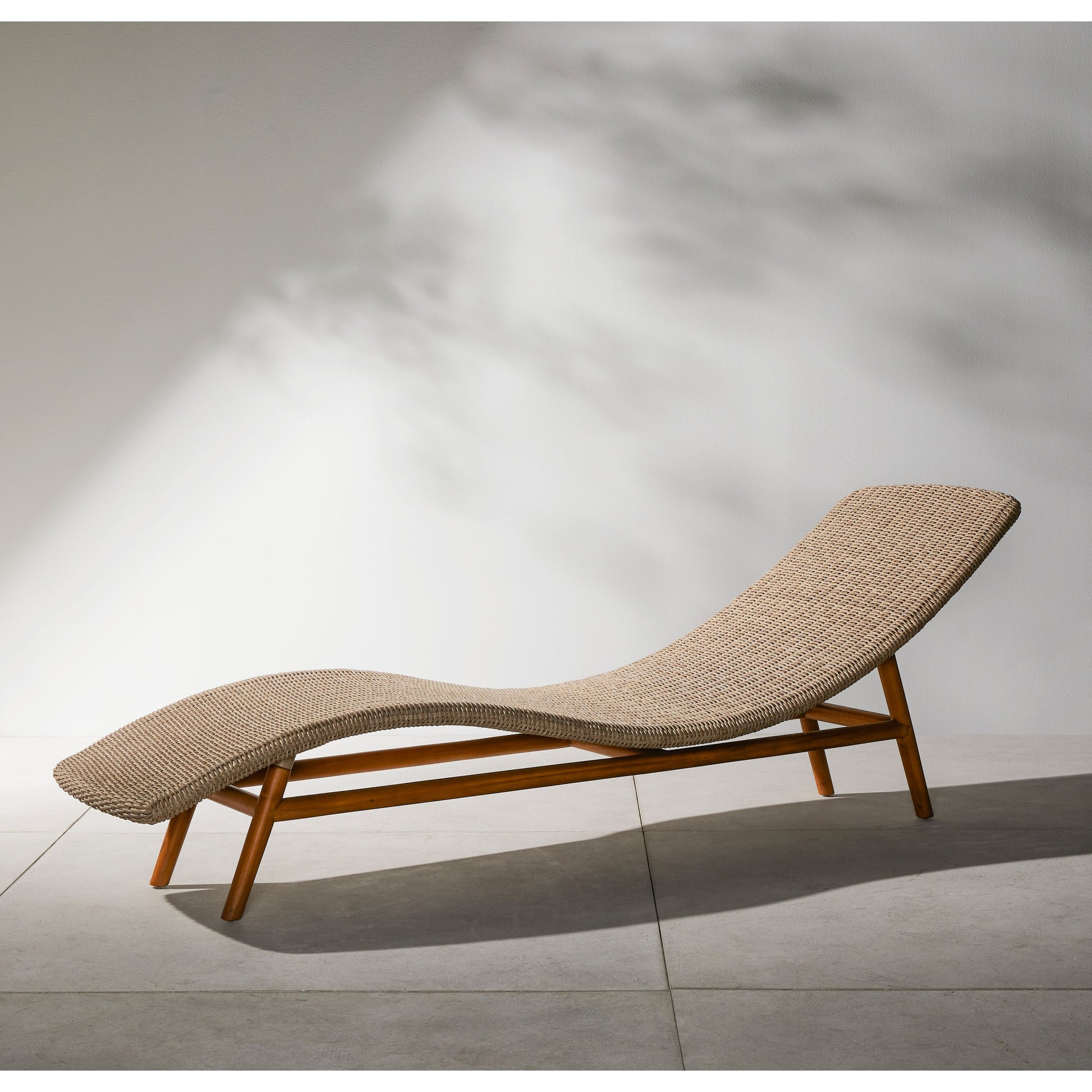 Portia Outdoor Chaise by Four Hands. Made from 100% polyethylene, solid teak, iron in a coastal style.