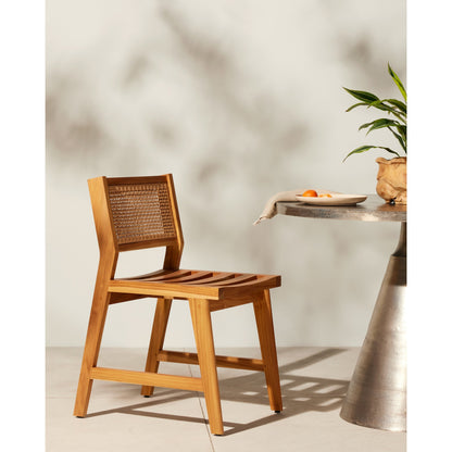 Merit Outdoor Dining Chair by Four Hands in faux rattan, natural teak. Made from solid fsc®-certified teak, 100% polyethylene in a transitional style.