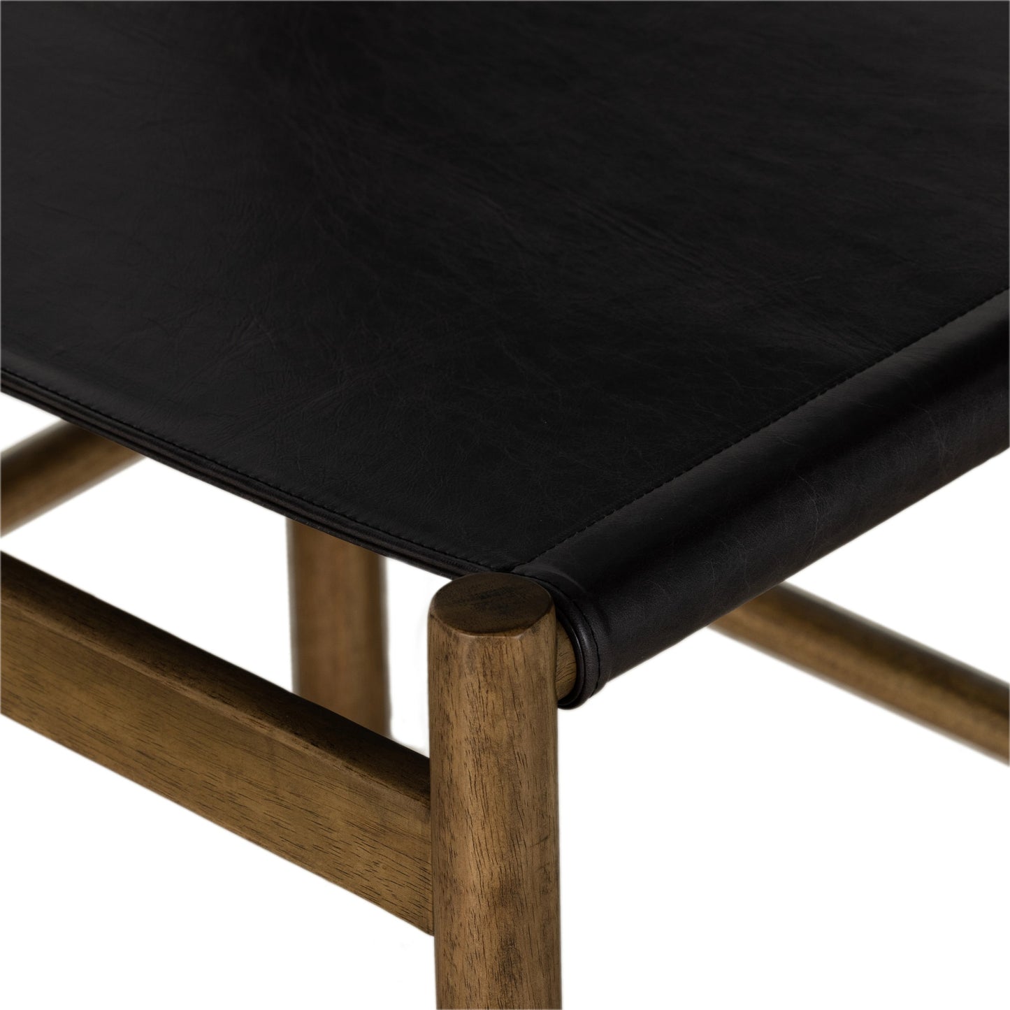 007 SI-1977440 | Closeup | Kena Dining Chair by Four Hands in sonoma black, vintage natural. Made from top grain leather, solid parawood in a modern style.